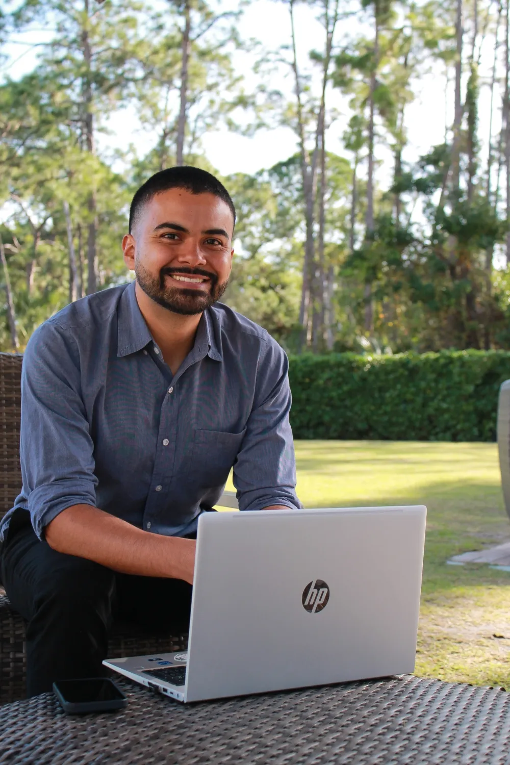 Erick Montano, founder of TechKnowledgy Team, smiling beside an open laptop